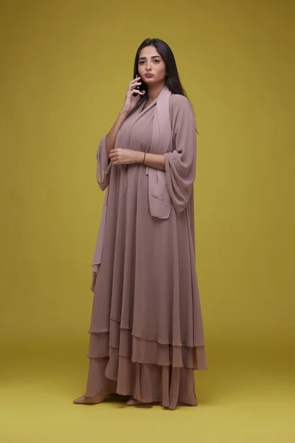 Saudi Woman with Smartphone in Beige Abaya Yellow Studio