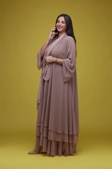 Saudi Woman in Mauve Abaya Talking on Smartphone