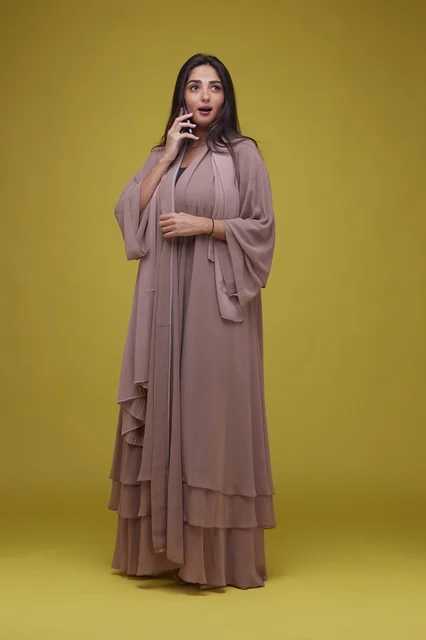 Saudi Woman Talking on Smartphone in Beige Abaya