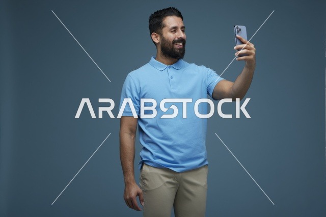 Saudi Man Taking Selfie with Smartphone in Studio