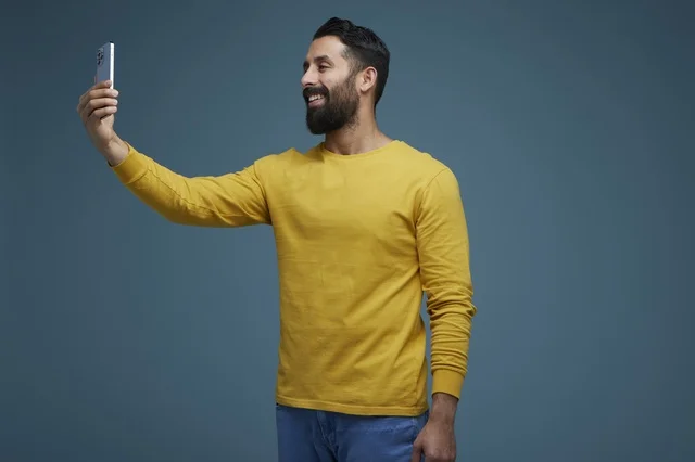 Saudi Man Taking Selfie with Smartphone in Studio