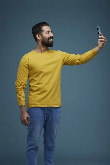 Saudi Man Taking Selfie with Smartphone in Studio