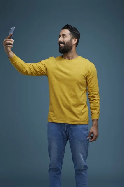 Saudi Man in Casual Wear Taking Smartphone Selfie