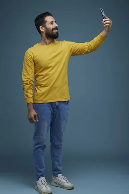 Saudi Man Taking Selfie with Smartphone in Studio