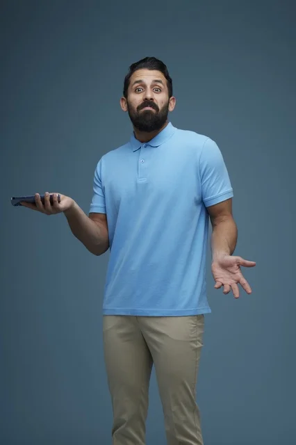 Confused Saudi Man Shrugging While Holding Smartphone