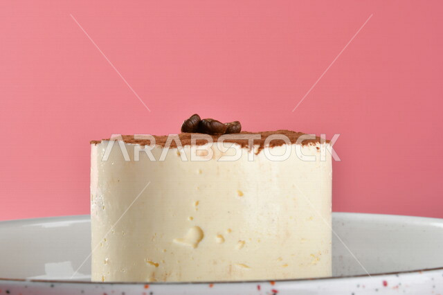 A delicious piece of cheesecake decorated with cocoa, cheesecake with cream layers, sweets and sugars, delicious candy pieces, colorful background, dessert, oriental dessert, Ramadan sweets, cold and delicious sweets