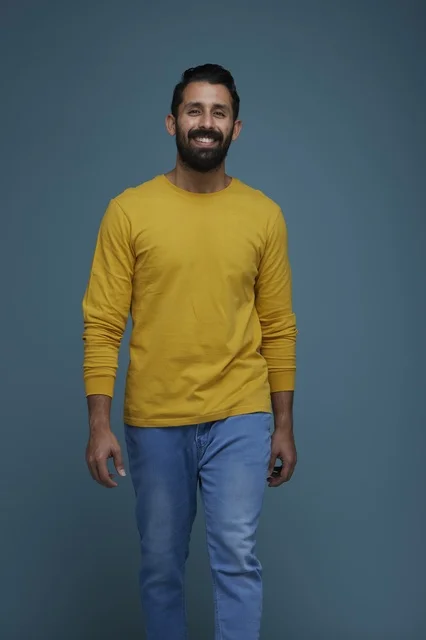 Smiling Saudi Man in Yellow Casual Shirt Walking in Studio