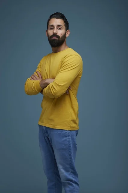 Saudi Man in Yellow Shirt with Arms Crossed