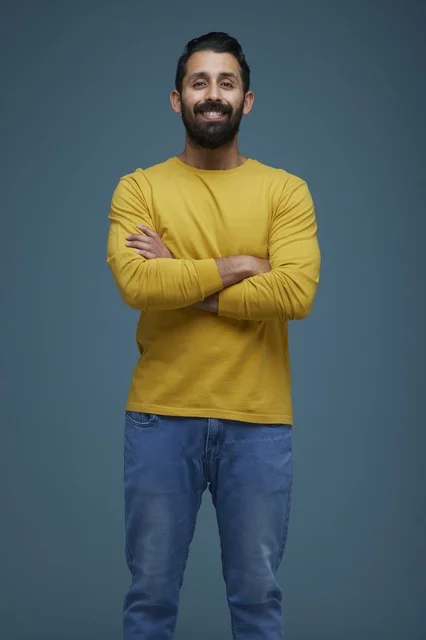 Saudi Man in Yellow Shirt and Jeans with Crossed Arms