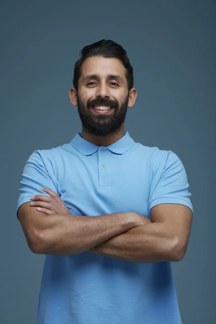 Smiling Saudi Man in Blue Polo Shirt Studio Portrait