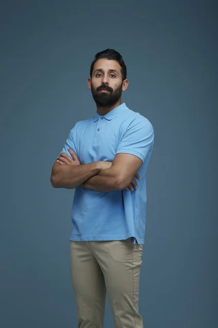 Saudi Young Man in Casual Polo Shirt with Arms Crossed