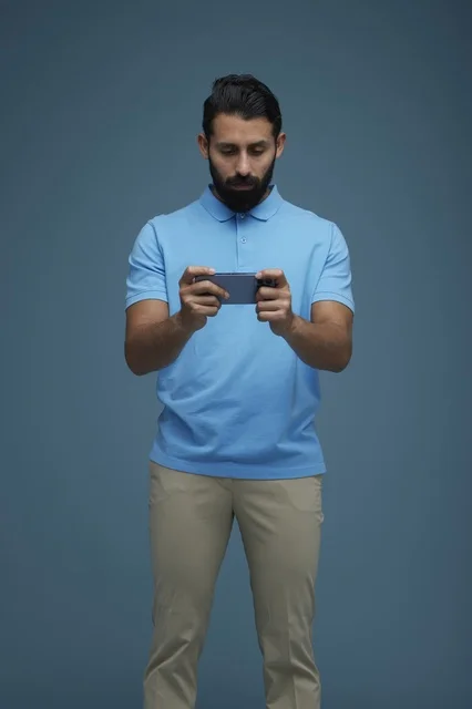 Young Saudi Man Playing Mobile Game in Studio
