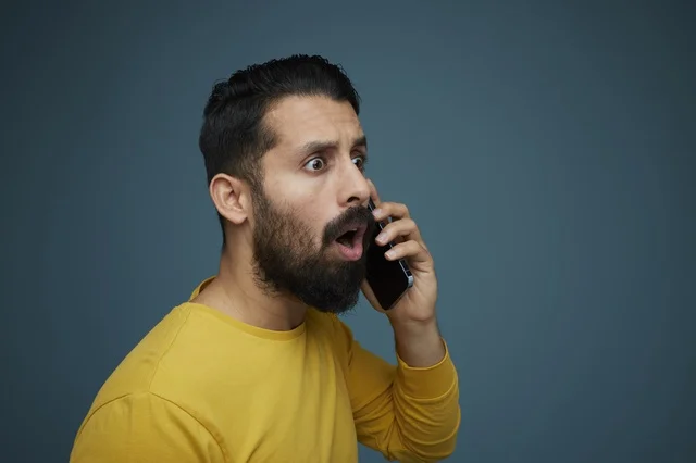 شاب سعودي مصدوم يتحدث عبر الهاتف بملابس كاجوال
