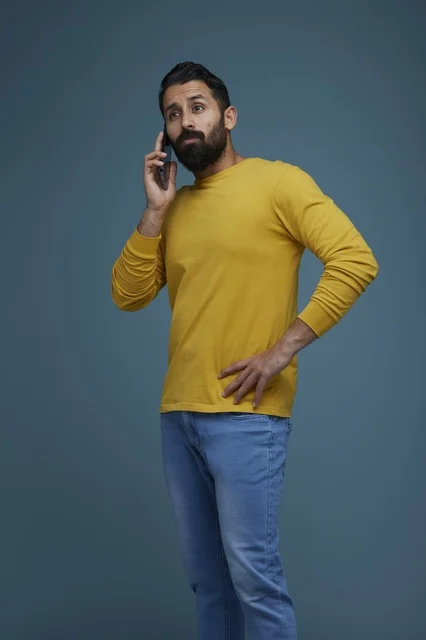 Saudi Man Talking on Smartphone in Casual Yellow Shirt