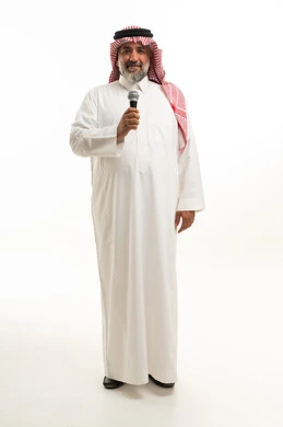 Saudi Man in Traditional Thobe Holding Microphone Studio