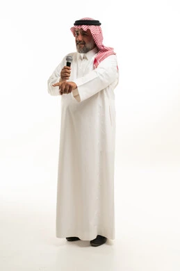 Saudi Man Speaking into Microphone on White Background
