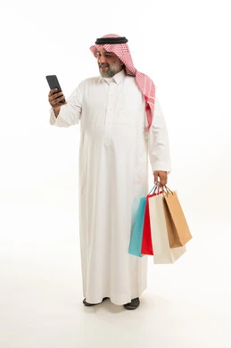 Saudi Man Holding Shopping Bags and Smartphone on White Saudi Man Holding Shopping Bags and Smartphone on White