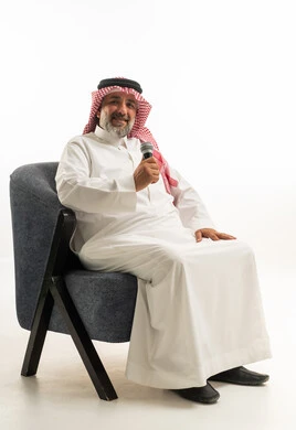 Saudi Man in Traditional Thobe Holding Microphone