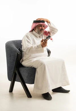 Saudi Man in Traditional Dress Playing Video Games
