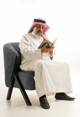 Saudi Man Reading Holy Quran in Traditional Attire