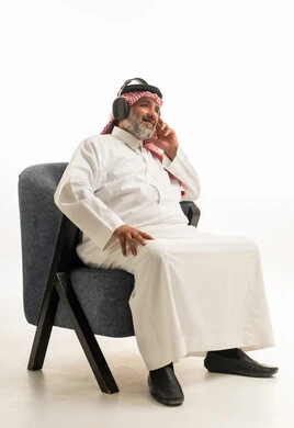 Saudi Man Wearing Headphones in White Studio