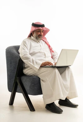 Saudi Man with Laptop in Traditional Attire