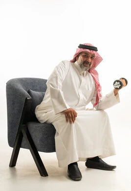 Saudi Man in Thobe Lifting Dumbbell Indoors