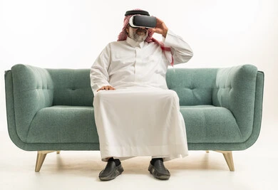 Saudi Man Wearing VR Headset on Sofa in Studio