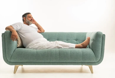 Middle Aged Arab Man Relaxing on Blue Sofa