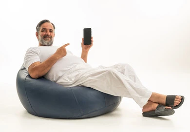 Saudi Man with Smartphone on Blue Bean Bag