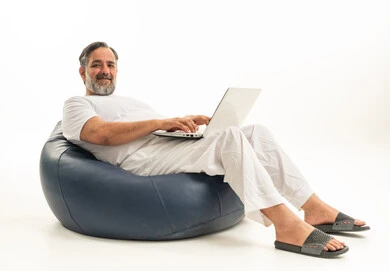Arab Man Using Laptop on Blue Beanbag Studio