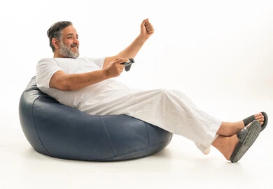 Middle Aged Saudi Man Playing Video Games on Bean Bag