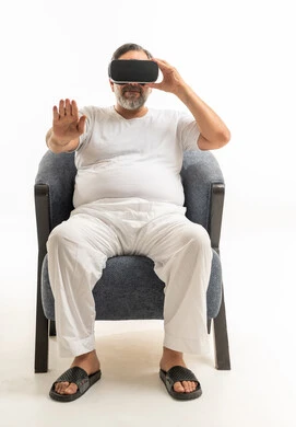 Middle-aged Arab Man Wearing VR Headset in Armchair