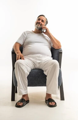 Saudi Man Talking on Smartphone in Blue Armchair
