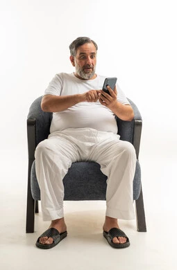 Saudi Man in White Underwear Using Smartphone