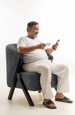 Saudi Man Shopping Online with Smartphone and Card
