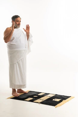 Middle Eastern Man in Ihram Praying on White Background