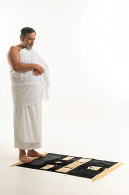 Muslim Man in Ihram on Prayer Mat White Background