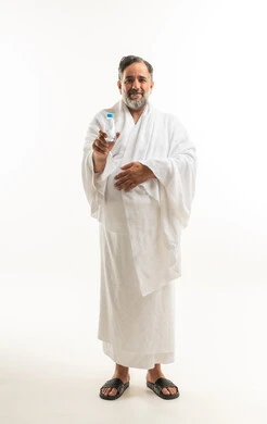 Arab Muslim Pilgrim in Ihram Attire Holding Water Bottle