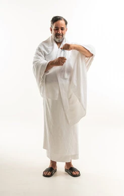 Saudi Man in Ihram Holding Water Bottle on White Background