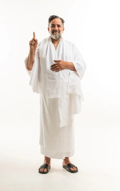 Saudi Man in Ihram Pointing Up for Hajj and Umrah