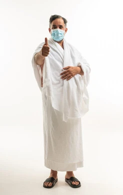 Muslim Pilgrim in Ihram Giving Thumbs Up with Mask