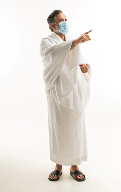 Middle-aged Saudi Man in Ihram Pointing with Mask