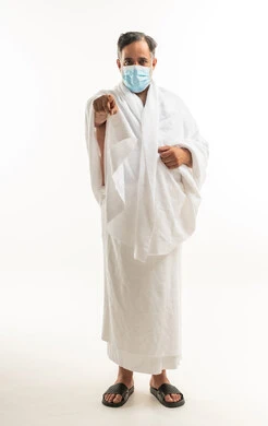 Arab Pilgrim in Ihram Wearing Mask Pointing Finger
