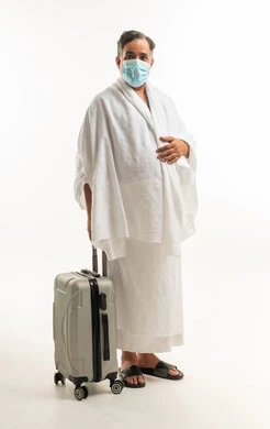 Arab Pilgrim in Ihram with Suitcase and Mask