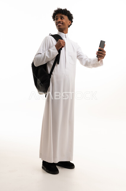 Saudi Student in White Thobe Holding Smartphone