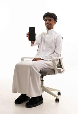 Saudi Man in White Thobe Holding Smartphone