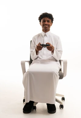Saudi Man in White Thobe Playing Video Games
