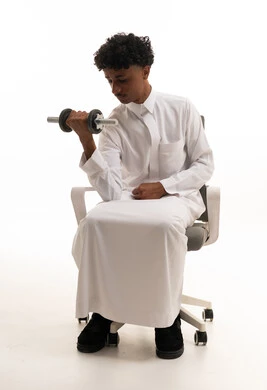 Saudi Man in Thobe Lifting Dumbbell Fitness Studio
