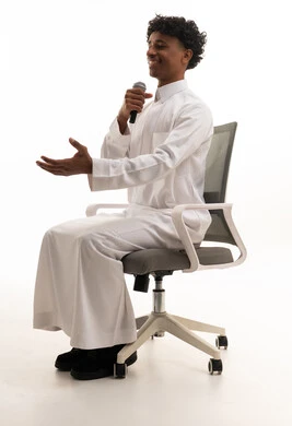 Saudi Man in Traditional Thobe Speaking into Microphone